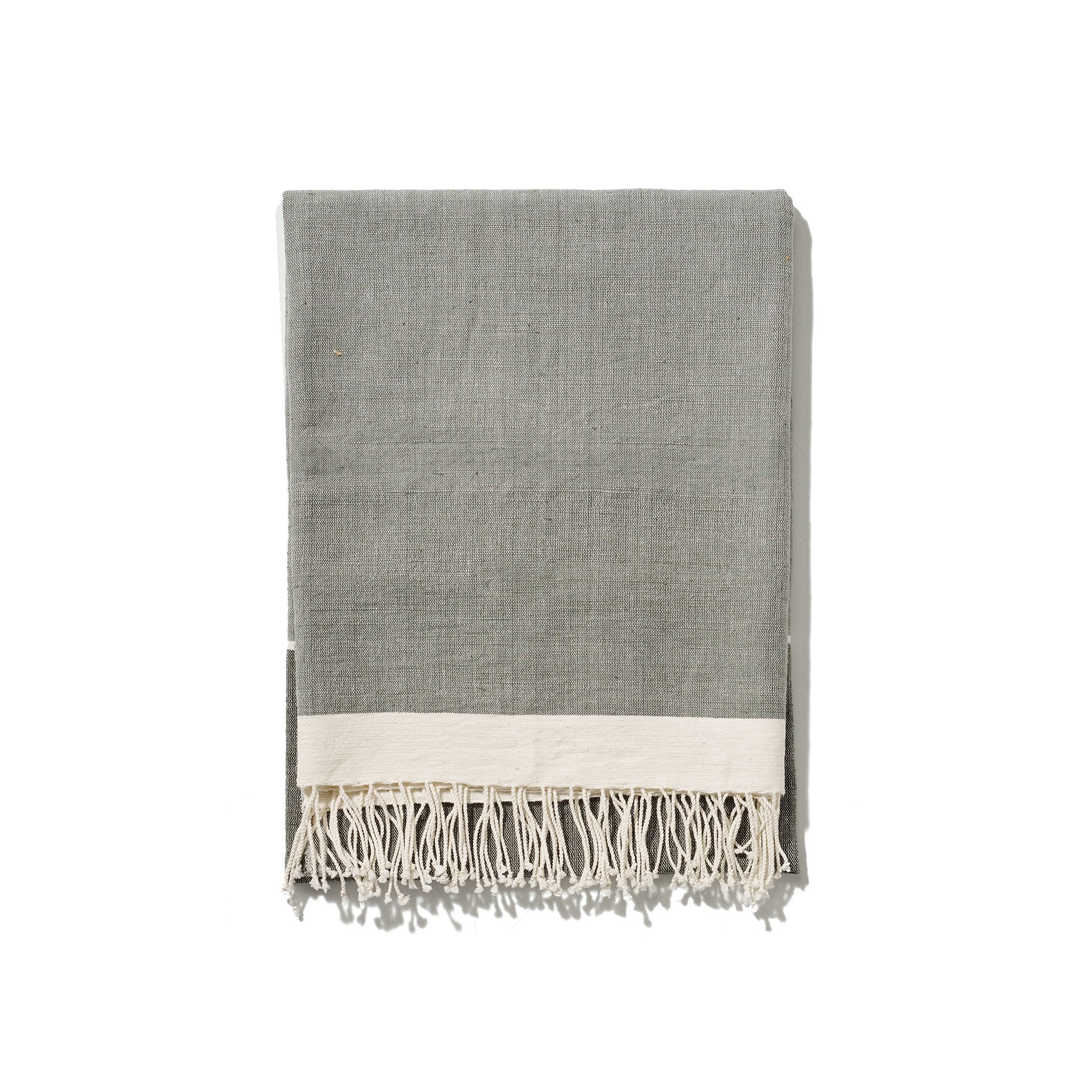 A traditional and timeless grey towel woven by hand from 100% Ethiopian cotton, dyed in small batches, and fringed by hand.