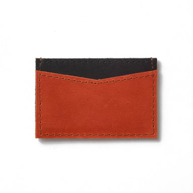 The perfect black colorblock credit card case to stand alone or fit into a handbag, made from sustainable leather and upcycled brass hardware.