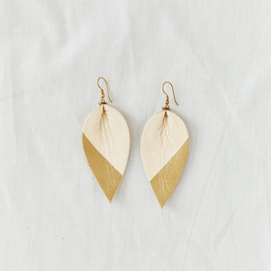 Classic design that transitions effortlessly from day to night, these white and gold leather leaf earrings are handcrafted from sustainable leather.