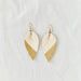 Classic design that transitions effortlessly from day to night, these white and gold leather leaf earrings are handcrafted from sustainable leather.