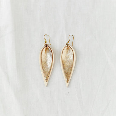 Classic design that transitions effortlessly from day to night, these gold and white leather leaf earrings are handcrafted from sustainable leather.