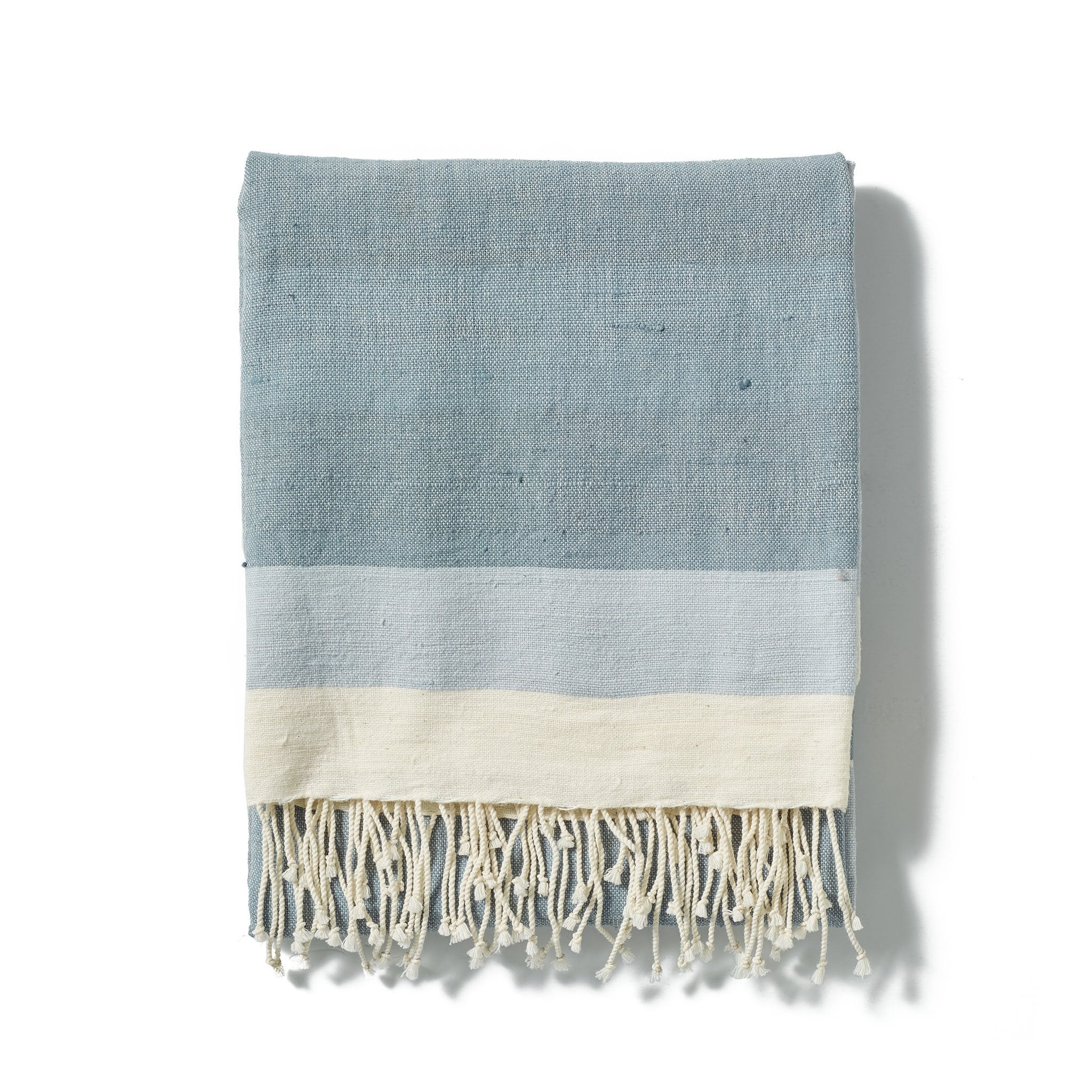 A traditional and timeless light grey towel woven by hand from 100% Ethiopian cotton, dyed in small batches, and fringed by hand.
