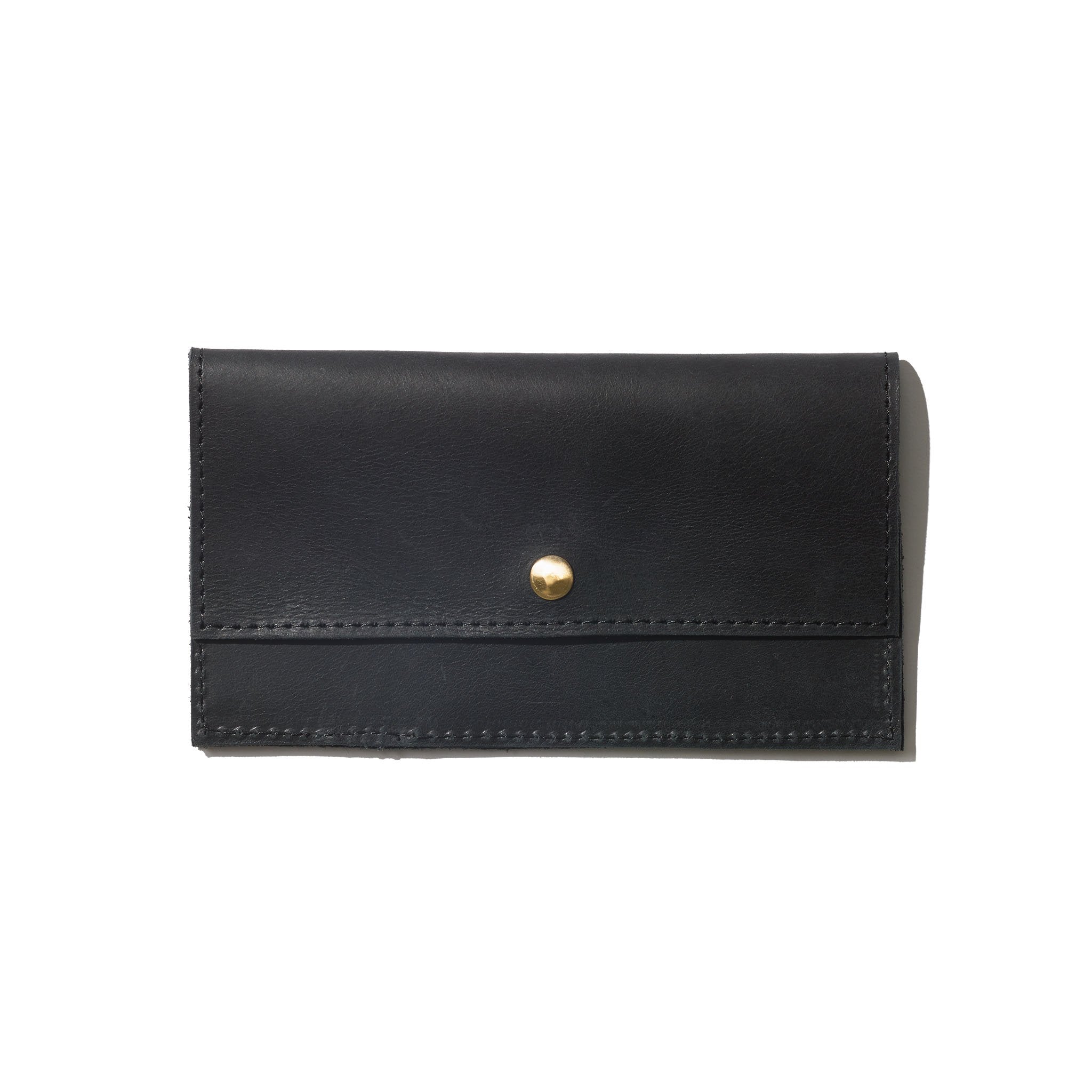 A black wallet handcrafted from sustainable leather featuring a brass snap button closure and a minimalist design.
