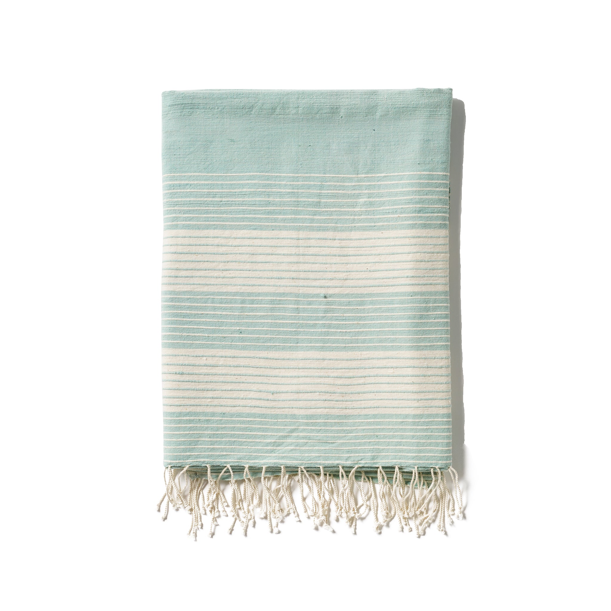 A traditional and timeless blue towel woven by hand from 100% Ethiopian cotton, dyed in small batches, and fringed by hand.