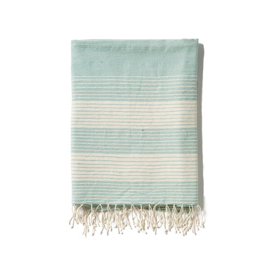 A traditional and timeless blue towel woven by hand from 100% Ethiopian cotton, dyed in small batches, and fringed by hand.