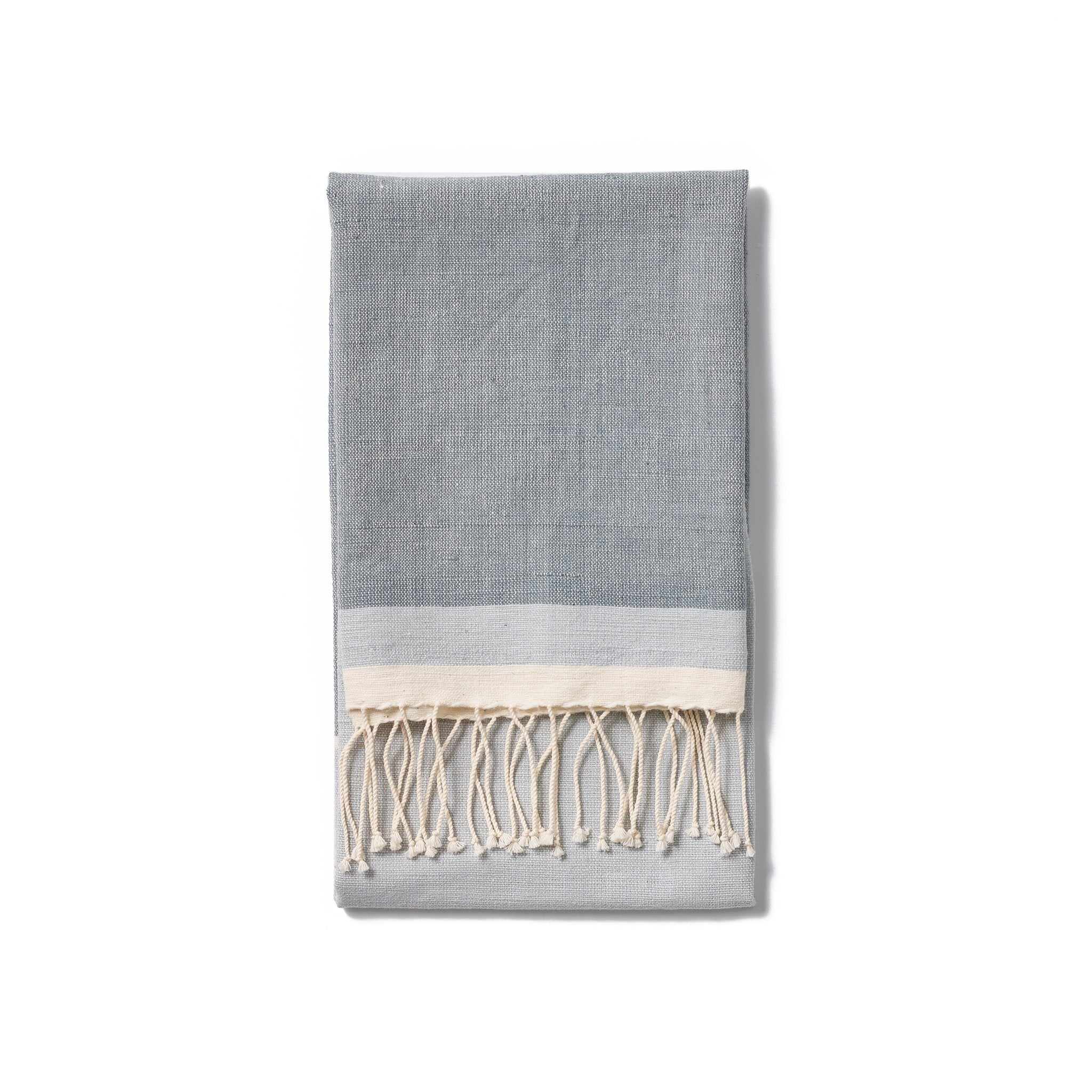 A traditional and timeless hand towel woven by hand from 100% Ethiopian cotton, dyed in small batches, and fringed by hand.