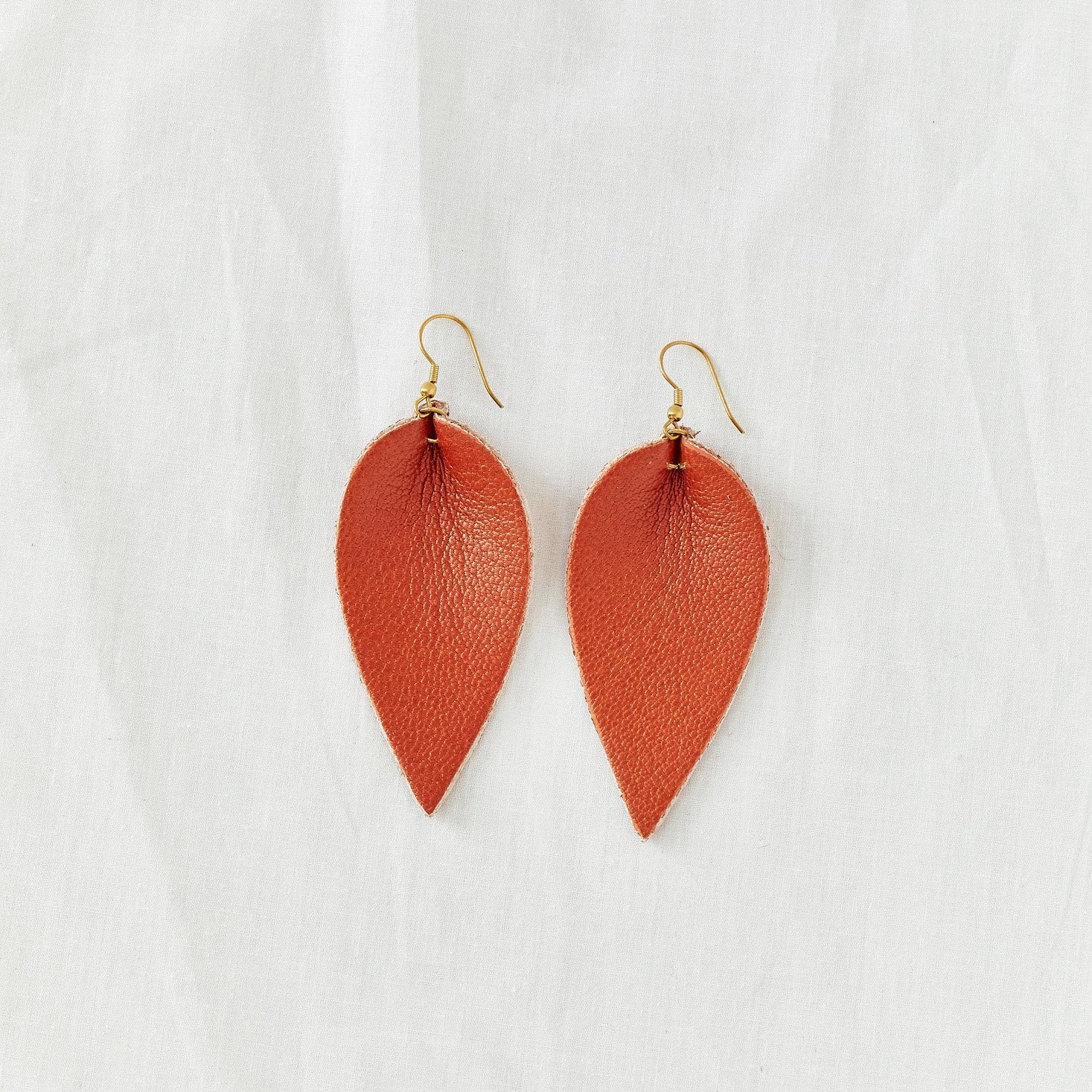 Classic design that transitions effortlessly from day to night, these brown leather leaf earrings are handcrafted from sustainable leather.