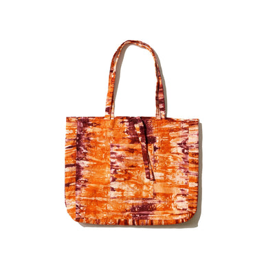 A carefree and charming orange tie-dye tote bag made from hand-spun 100% organic cotton and all natural dye.