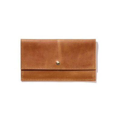 A brown wallet handcrafted from sustainable leather featuring a brass snap button closure and a minimalist design.