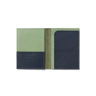 A green and blue passport wallet perfect for everyday use and handcrafted from sustainable leather.