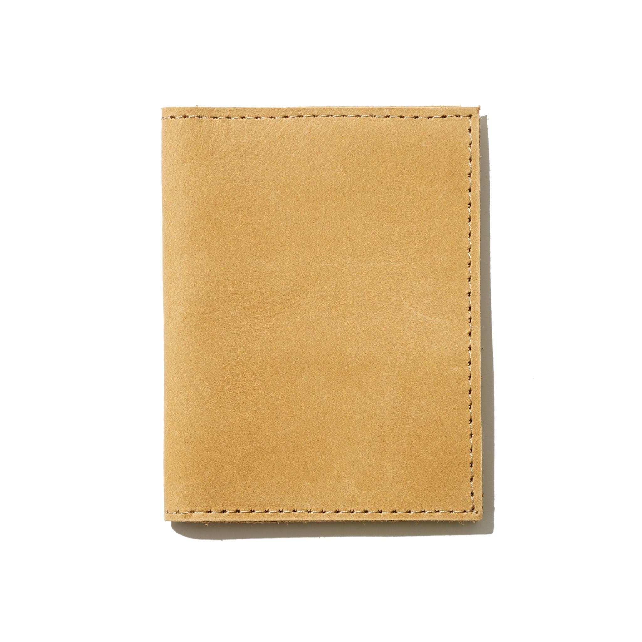 A yellow passport wallet perfect for everyday use and handcrafted from sustainable leather.
