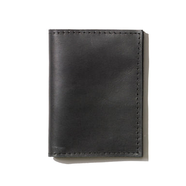 A black passport wallet perfect for everyday use and handcrafted from sustainable leather.