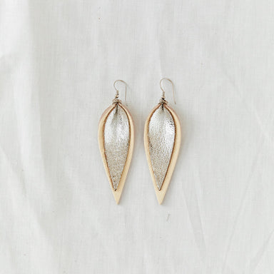 Classic design that transitions effortlessly from day to night, these white and silver leather leaf earrings are handcrafted from sustainable leather.