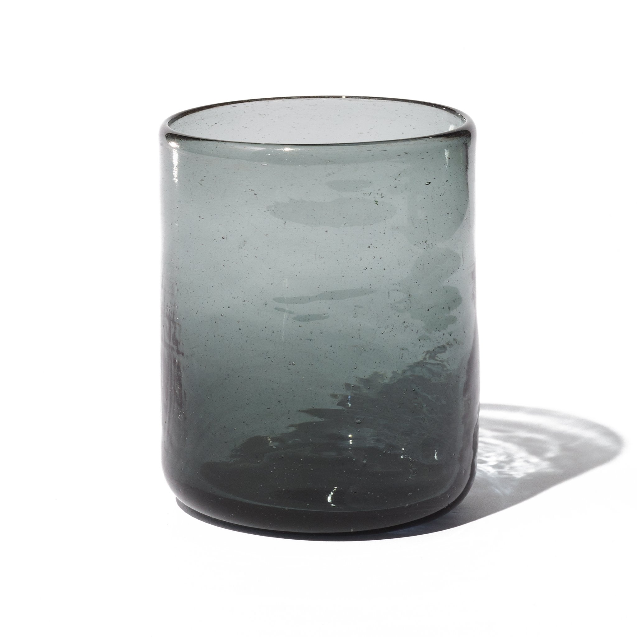 A grey tumbler handcrafted in small batches from 100% recycled glass.