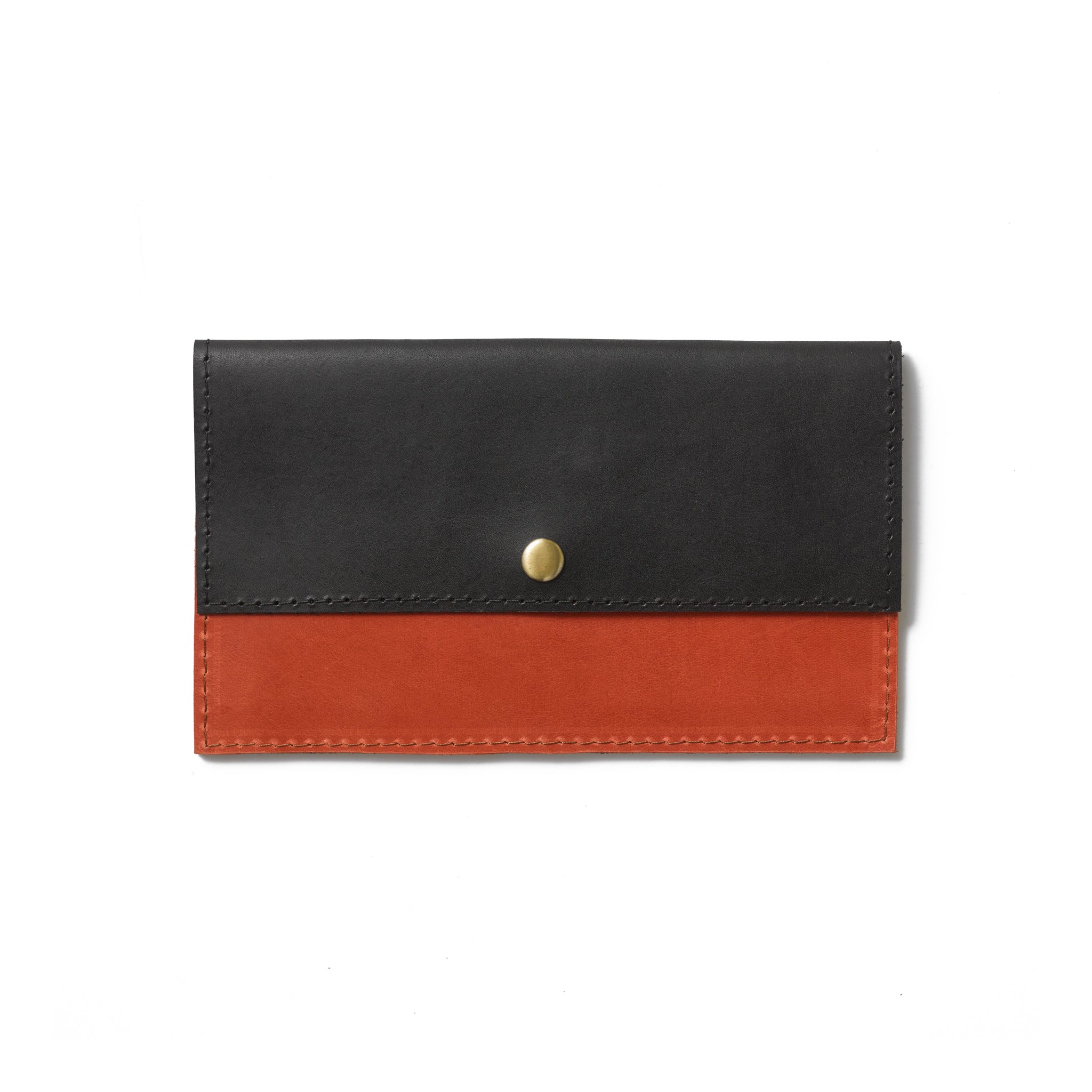 A colorblock wallet handcrafted from sustainable leather featuring a brass snap button closure and a minimalist design.